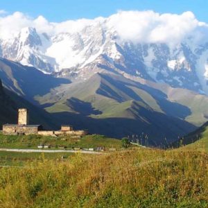 La Maria church Ushguli with spectacular snow capped mountains - georgia armenia azerbaijan tours