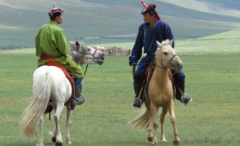 Mongolia-Naadam-two-men-on-horses.jpg